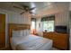 Cozy bedroom with a ceiling fan, queen bed, and plenty of storage with a dresser at 10301 Us Highway 27 # 84, Clermont, FL 34711
