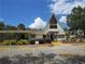 Exterior view of a community clubhouse with ample parking and well-maintained landscaping at 10301 Us Highway 27 # 84, Clermont, FL 34711