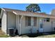 Charming single-story home featuring vinyl siding, a brown roof, and an efficient cooling system at 10301 Us Highway 27 # 84, Clermont, FL 34711