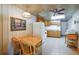 Cozy kitchen with a dining area, bright lighting, wood cabinets, and white appliances at 10301 Us Highway 27 # 84, Clermont, FL 34711