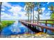 Beautiful lake view featuring a private dock, clear blue water, and scenic trees at 10301 Us Highway 27 # 84, Clermont, FL 34711