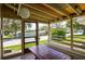 Inviting screened porch with a wooden picnic table and bench seating, perfect for outdoor relaxation at 10301 Us Highway 27 # 84, Clermont, FL 34711