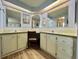 Bright bathroom featuring double sinks, mirrored vanity, and ample counter space at 111 Azalea Trl, Leesburg, FL 34748