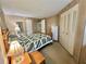 Cozy bedroom featuring wood-paneled walls, comfortable furnishings, and closet space for storage at 111 Azalea Trl, Leesburg, FL 34748