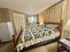 Comfortable bedroom with a wooden bed frame, stylish bedding, and plenty of natural light at 111 Azalea Trl, Leesburg, FL 34748