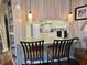 Cozy breakfast bar features unique pendant lighting and seating, with a view of the kitchen at 111 Azalea Trl, Leesburg, FL 34748