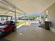 Spacious carport perfect for parking vehicles and golf carts with room for outdoor activities at 111 Azalea Trl, Leesburg, FL 34748