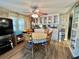 Charming dining area features a wooden table with seating for six and built-in display cabinets at 111 Azalea Trl, Leesburg, FL 34748