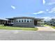 Charming single-story home with covered parking and a well-maintained front lawn on a sunny day at 111 Azalea Trl, Leesburg, FL 34748