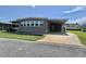 Lovely single-story home with covered parking, well-manicured lawn, and convenient street access at 111 Azalea Trl, Leesburg, FL 34748