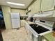 Efficient kitchen with white appliances and cabinets at 111 Azalea Trl, Leesburg, FL 34748