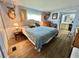Inviting main bedroom features warm lighting and comfortable furnishings, leading to the en-suite bath at 111 Azalea Trl, Leesburg, FL 34748