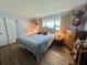 Serene bedroom featuring a plush bed, decorative accents, and natural light from the window at 111 Azalea Trl, Leesburg, FL 34748