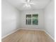 Empty bedroom with light wood floors and ceiling fan at 11759 Se 91St Cir, Summerfield, FL 34491