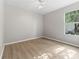 Empty bedroom with light wood floors and window at 11759 Se 91St Cir, Summerfield, FL 34491