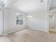 Formal dining room showcasing light walls, wood-look floors, and a chandelier, perfect for entertaining guests at 11759 Se 91St Cir, Summerfield, FL 34491