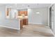 Open floor plan with kitchen view; light wood flooring and neutral tones at 11759 Se 91St Cir, Summerfield, FL 34491
