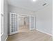 Home office space featuring light walls, wood-look floors, and glass French doors leading to other rooms at 11759 Se 91St Cir, Summerfield, FL 34491