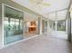 Screened lanai featuring tile flooring and views of the kitchen and living area through sliding glass doors at 11759 Se 91St Cir, Summerfield, FL 34491