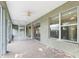 Screened porch with ceiling fan and views of the backyard, perfect for enjoying outdoor living at 11759 Se 91St Cir, Summerfield, FL 34491