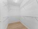 Spacious walk-in closet with ample shelving and wood flooring at 11759 Se 91St Cir, Summerfield, FL 34491