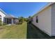 Beautiful backyard featuring well-maintained lawn, screened lanai, and lush landscaping at 1417 Forest Acres Dr, The Villages, FL 32162