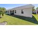 Lush backyard featuring a well-maintained lawn, a patio, and vibrant greenery at 1417 Forest Acres Dr, The Villages, FL 32162