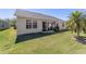 Expansive backyard with lush lawn, a patio, and a well-maintained exterior at 1417 Forest Acres Dr, The Villages, FL 32162