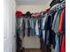 Walk-in closet with rods and shelves provides ample storage space for clothing, shoes, and accessories at 1417 Forest Acres Dr, The Villages, FL 32162