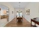 Formal dining room with hardwood floors, chandelier, and ample seating for Gathering meals at 1417 Forest Acres Dr, The Villages, FL 32162