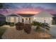 Charming single-story home featuring a well-maintained lawn and inviting curb appeal with a lovely sky at 1417 Forest Acres Dr, The Villages, FL 32162