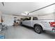 Spacious garage with ample storage, a silver truck, and a well-organized shelving system at 1417 Forest Acres Dr, The Villages, FL 32162