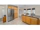 Well-appointed kitchen with stainless steel refrigerator, granite counters and tile flooring and a breakfast nook at 1417 Forest Acres Dr, The Villages, FL 32162