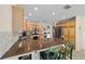 Bright kitchen featuring granite countertops, stainless steel appliances and a breakfast bar at 1417 Forest Acres Dr, The Villages, FL 32162