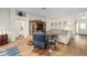 Open-concept living area with hardwood floors, entertainment center, and comfortable seating at 1417 Forest Acres Dr, The Villages, FL 32162