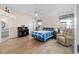 Cozy main bedroom featuring hardwood floors, a ceiling fan, and a private ensuite bathroom at 1417 Forest Acres Dr, The Villages, FL 32162