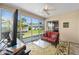 Inviting sunroom with large windows overlooking the backyard, comfortable seating, and tile flooring at 1417 Forest Acres Dr, The Villages, FL 32162