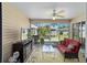 Relaxing sunroom with ample natural light, ceiling fan, tile flooring, and comfortable seating at 1417 Forest Acres Dr, The Villages, FL 32162
