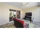 Bright sunroom with sliding glass door access to the backyard, ceiling fan, and cozy seating area at 1417 Forest Acres Dr, The Villages, FL 32162