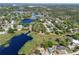 Stunning aerial view showcasing the community's lakes and lush greenery, highlighting its natural beauty at 17108 Pine Ridge Dr, Umatilla, FL 32784