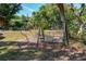 Inviting backyard with a porch swing and mature trees offering a relaxing outdoor space at 17108 Pine Ridge Dr, Umatilla, FL 32784