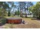 Large backyard featuring an above-ground swimming pool surrounded by mature trees and greenery at 17108 Pine Ridge Dr, Umatilla, FL 32784