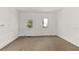 Cozy bedroom featuring neutral carpet and a large window, providing ample natural light at 17108 Pine Ridge Dr, Umatilla, FL 32784
