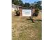 The Three Lakes Community sign is made of white concrete and brick and surrounded by grass at 17108 Pine Ridge Dr, Umatilla, FL 32784