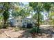 Charming single-story home with a lush, tree-filled yard and well-maintained landscaping at 17108 Pine Ridge Dr, Umatilla, FL 32784
