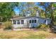 A home's front yard with a garden, flowers, and large picture window at 17108 Pine Ridge Dr, Umatilla, FL 32784