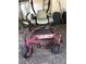 A red and gray lawn mower sits in front of a white shed on the property at 17108 Pine Ridge Dr, Umatilla, FL 32784