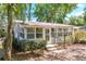 Cozy sunroom surrounded by large windows, offering abundant natural light and views of the outdoors at 17108 Pine Ridge Dr, Umatilla, FL 32784