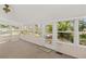 Bright sunroom filled with natural light, featuring carpet flooring and views of the outdoors at 17108 Pine Ridge Dr, Umatilla, FL 32784