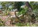 Outdoor statue of a person riding a horse surrounded by lush greenery at 17108 Pine Ridge Dr, Umatilla, FL 32784